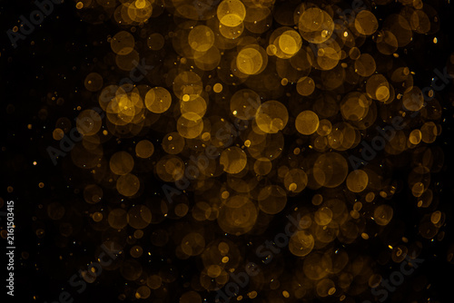 Blurred photo with golden dots visible glittering, shining brightly look and feel luxurious