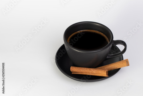 Minimal Black Coffee Cup with Cinnamon and Copy Space