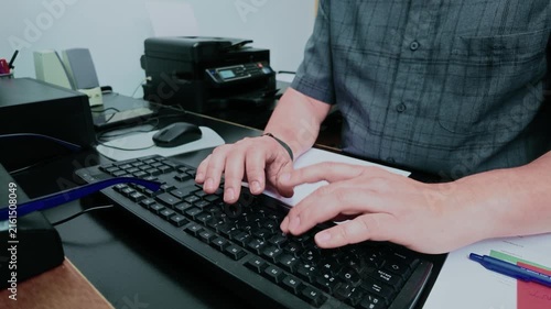 Office worker hands typing on keyboard
