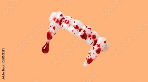 Vampire fangs with fake blood on orange background