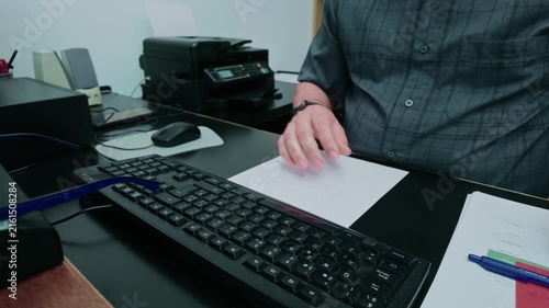 Office worker typing on a keyboard and later taking notes