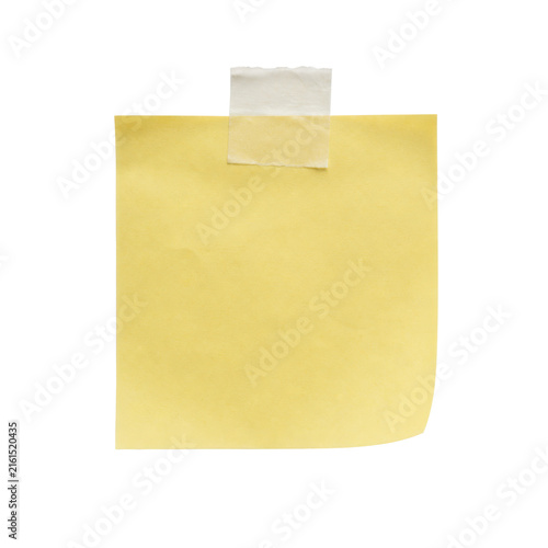 Фотография Empty yellow sticky note with a curled corner and masking tape attached to a whi