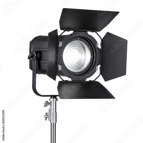 Fotografie Professional black studio light with barn doors and a bright Fresnel lens on a s