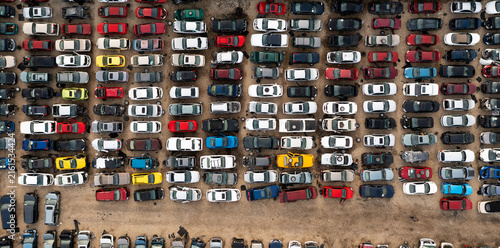 Damaged vehicles packed in rows at an auto salvage yard