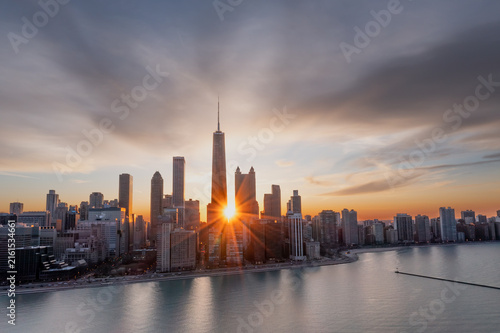 Sunburst between Chicago skyscrapers at sunrise