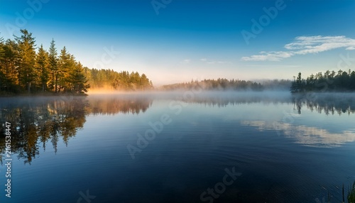 silent morning mist lingers on calm lake surface serene calm