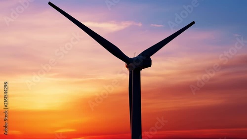 Wind turbine silhouette rotates against vibrant sunset sky 4k AI generated