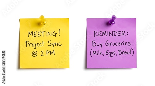 Two square sticky notes in yellow and purple with handwritten text reminders attached with pins on a clean surface