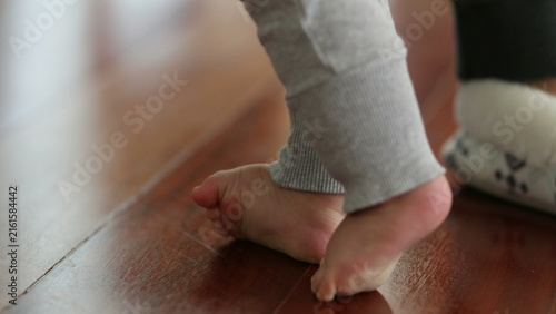 Konstfotografi Baby feet learning to walk and to stand-up to remain upright