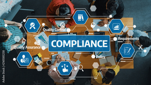 Obraz na płótnie A diverse team collaborates at a conference table focused on compliance, quality control, assurance, and policy development to enhance business performance and success