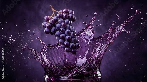 Dark grapes splash into purple juice creating dynamic motion and vibrant liquid art.