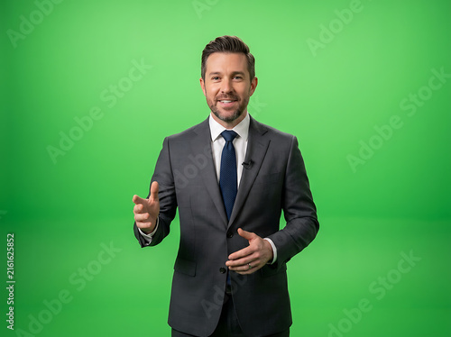Professional news anchor in suit presenting on green screen background