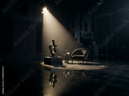 Modern art sculpture and armchair in dark studio with dramatic spotlight illumination