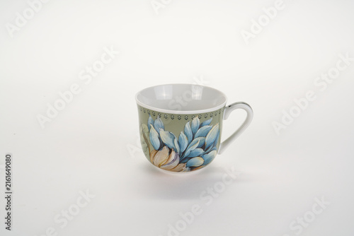 Photography A pretty ceramic tea cup with blue flower patterns and elegant gold trim for a w