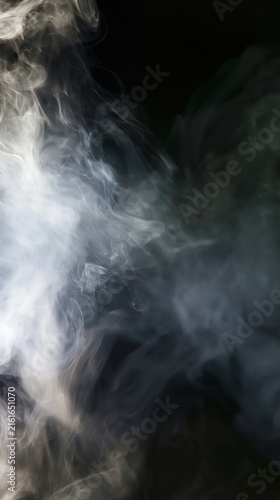 Abstract white smoke and translucent vapor flowing across a dark background, creating an ethereal atmospheric texture with soft movement and copy space.