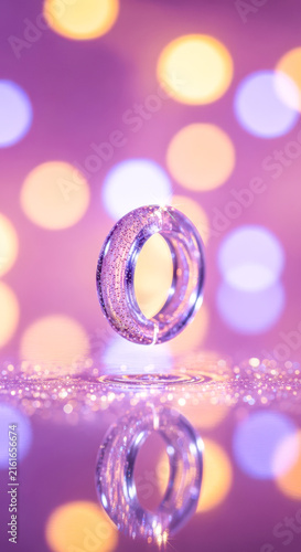 Transparent textured ring reflecting in shiny surface