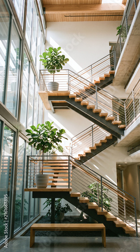 Bright modern office staircase with plants, symbolizing growth and wellness
