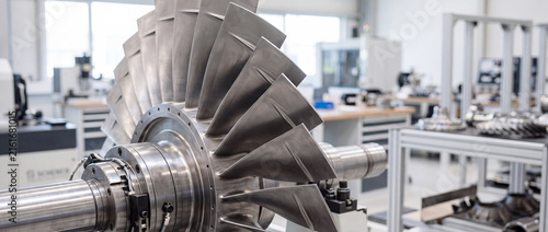 Industrial gas turbine rotor with blades in modern engineering workshop inspection and assembly