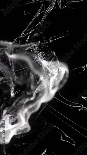 Animation grey ring of smoke over light on moving shiny black plastic