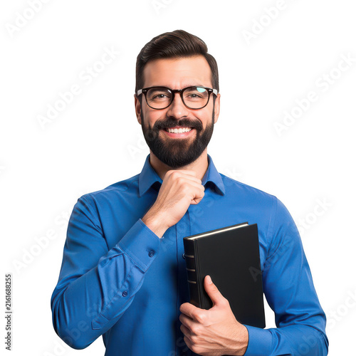 Smiling bearded man in blue shirt holding a black book isolated on transparent background