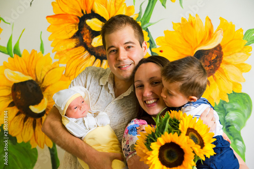 Family portrait of husband, wife, 1 year old kid and newborn baby boy