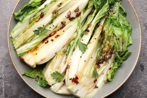 Konstfotografi Tasty cooked bok choy cabbages with sesame seeds and sauce served on grey table,