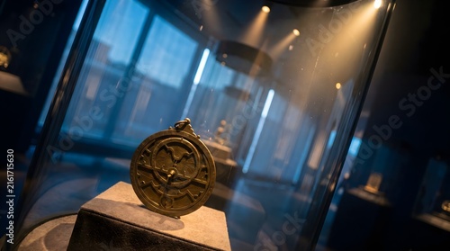 Antique Brass Astrolabe Exhibited in a Dimly Lit Museum Glass Vitrine