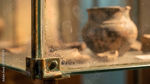 Macro View of Condensation and Fingerprints on a Museum Glass Case Housing Ancient Pottery