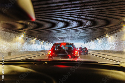 Canvastavla Cars stopped inside urban tunnel during summer traffic jam, red taillights glowi