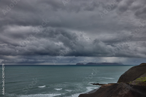 Фотография storm clouds roll over San Lorenzo Island as seen from the cliffs of Miraflores, Lima, casting a moody, atmospheric veil over the Pacific coastline