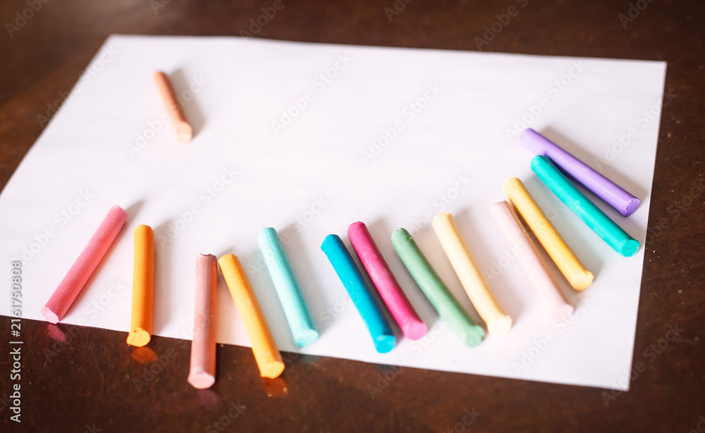 Fototapeta premium Colored pencils and crayons scattered on wooden table, creative workspace. Pencils, crayons, colored, scattered, table, wooden, workspace