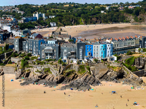 Quadro su tela Seaside resort town with pastel buildings overlooking sandy beach and rocky head