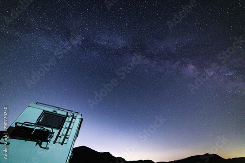 Night sky, milky way core over a parked camper in Campo Imperatore, Abruzzo, Italy.