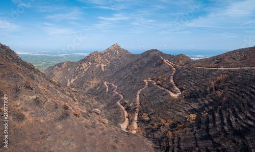 Konstfotografi Panoramic view of blackened mountain ridges after wildfire in Serra d'Espada, Ca