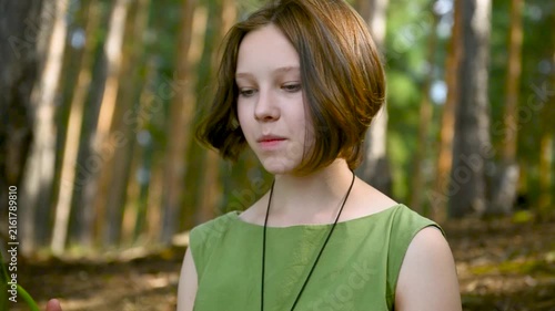 Beautiful calm young Caucasian teenage girl looking at camera.