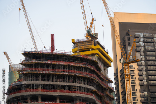 Принти на полотні Tower cranes and modern structures erected during the massive construction project symbolize continuous urban development, future growth, and ongoing engineering work