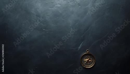 Top Down View of Vintage Golden Brass Compass on Dark Plaster Texture Background with Copy Space