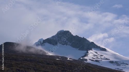 Antarctica Beautiful Mountain Peak with Low Hanging Clouds at Sunset. Snow Covers the Mountain, Blue Sky. Beautiful Nature Remote Destination
