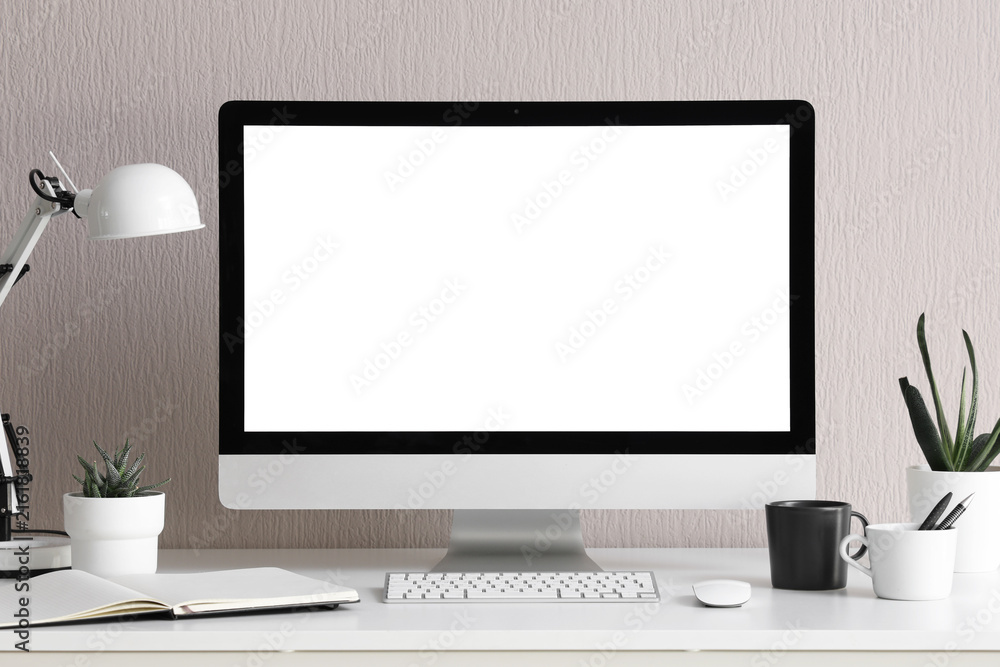 Fototapeta premium Modern home office setup with blank computer screen, remote work and productivity concept, clean desk with technology