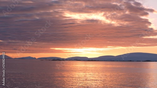 Stunning Sunset in Antarctica. Cruise Ship View Sailing Through Ocean Purple, Orange, Colorful Sky and Clouds. Beautiful Nature.