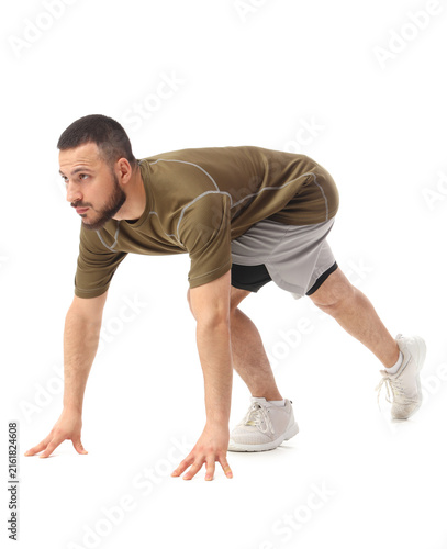 Fitness and healthy lifestyle, young man in starting position ready to run, a...