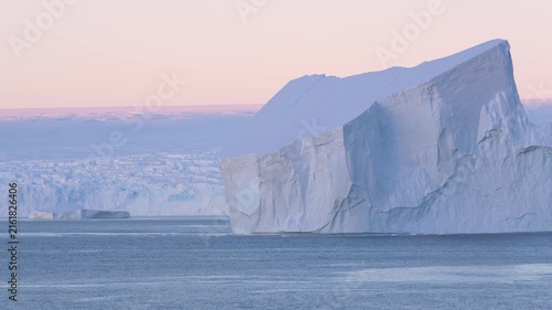 Antarctica Huge Tabular Icebergs at Sunset. Beautiful Snow Covered Mountains Epic Remote Nature Destination. Incredible Massive Ice Floating