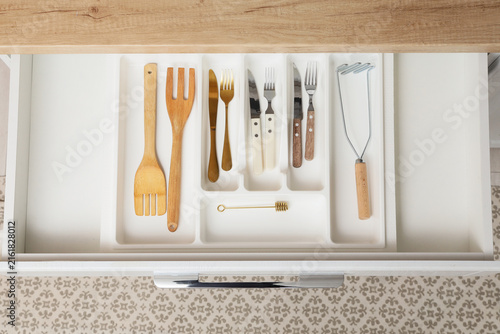 Fotografie Kitchen organization and home living, top view of an open drawer with various co