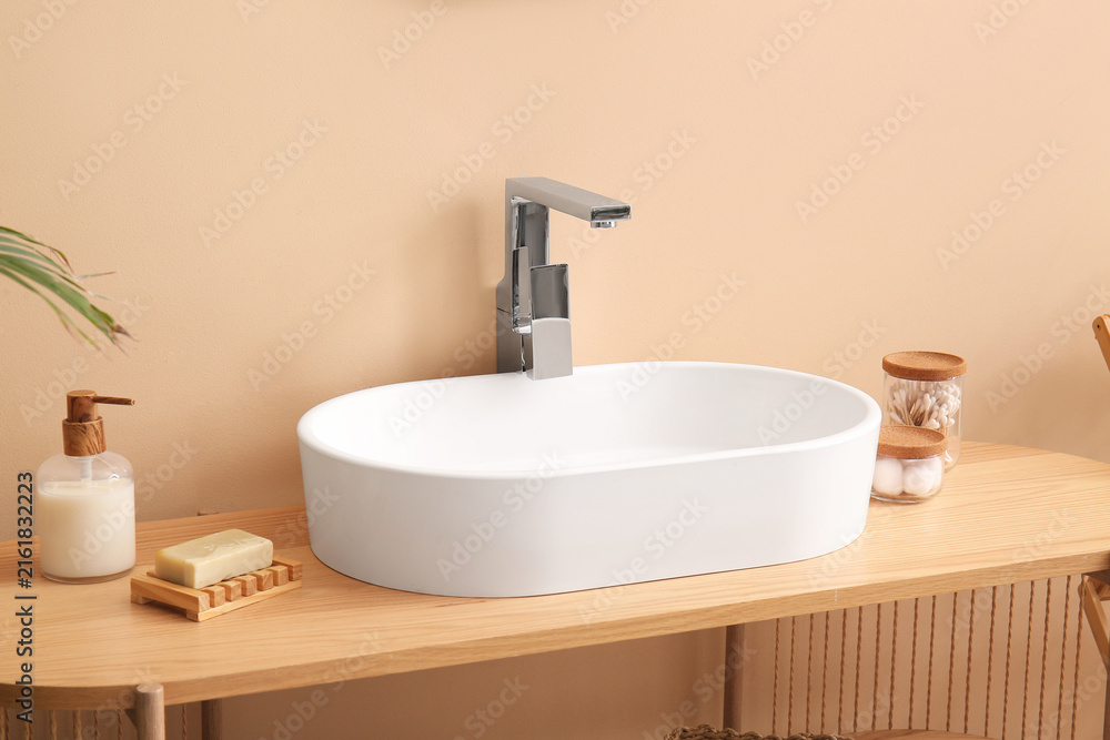 Fototapeta premium Modern bathroom design and home decor, white ceramic sink with chrome faucet on wooden counter, minimalist interior