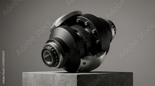 Matte black precision gear joint mechanical component with brushed aluminum accents on studio pedestal illustrating advanced engineering innovation, modern industrial hardware technology