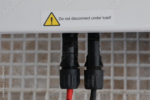 Fotografía Close up of solar panel connectors with warning label Do not disconnect under lo