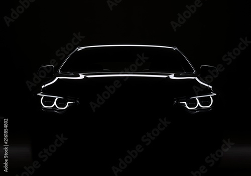 Sleek, dark sedan front, illuminated headlights piercing the night