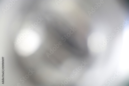 Close-up of a shiny metallic spherical object with reflective surface on a blurred background