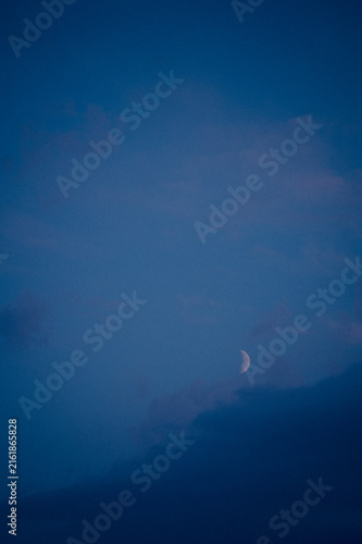 Photography Crescent moon in the blue evening sky