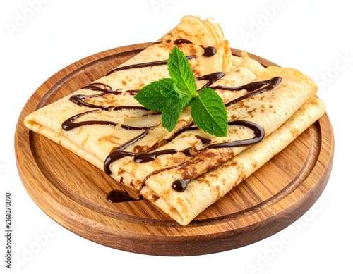 Stacked thin pancakes with chocolate drizzle, mint garnish, served on a wooden plate